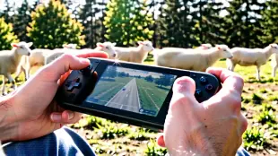 AI Video: An extreme close-up shot focusing on the handheld console. We see the gamer's...
