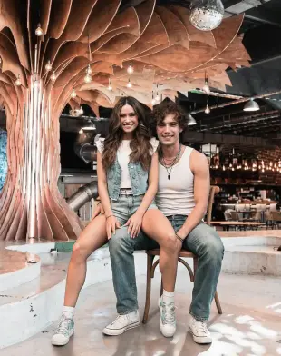 AI Video: Animate the scene so the boy bounces his seated leg (the one the girl is...