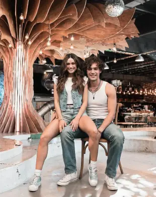 AI Video: Animate the scene so the boy bounces his seated leg (the one the girl is...