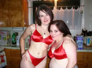 AI Video: Two women turn towards each other and kiss passionately while caressing each...