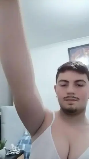 AI Video: Remove his facial hair and make him take off his shirt make his hair rainbow...