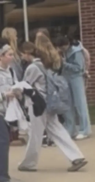 AI Video: The girl in the middle of the photo starts kissing the girl to the left of...