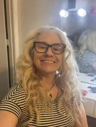 AI Video: The woman pulls off her shirt and reveals her large natural breasts that...