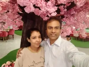 AI Video: Make a video of above couple kissing passionately in garden.