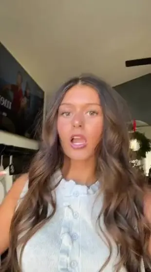 AI Video: Have the woman flip all her long hair completely over her face (none of her...