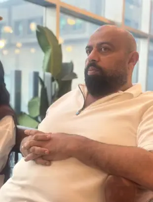 AI Video: Make this man get up from his chair and start madly dancing