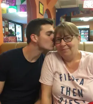 AI Video: Change the girls shirt to a red spaggittii strap tank top with ample cleveage...