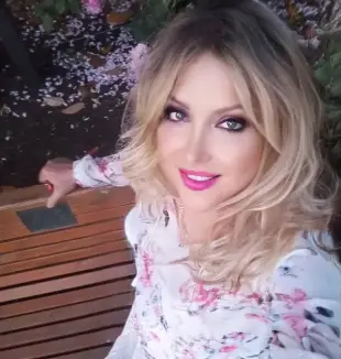 AI Video: Girl stand's up and smiles as she walks past camera, zoom back to show full body