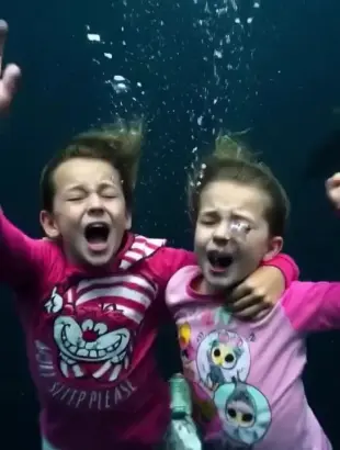 AI Video: While they're both drowning deep underwater, they both take off all of their...