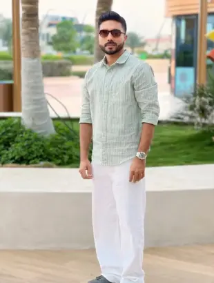 AI Video: A cinematic vertical 9:16 shot of this man attached in the photo sitting...