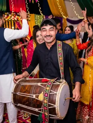 AI Video: The one who has a drum in his hand plays the drum from left side left hand...