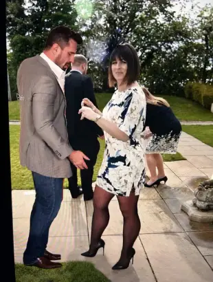 AI Video: A Woman with cream floral dress, black holdups and black high heels walks...