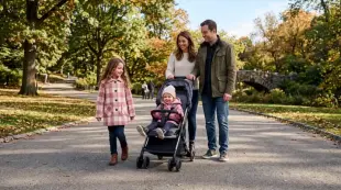 AI Video: 3-year-old girl wearing all-pink jacket sitting in narrow single stroller...