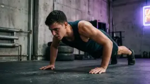 AI Video: , young man doing intense push-ups in a dark urban room, sweat visible,...