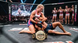 AI Video: blonde sterke mma vrouw in SDMbox/MMA logo's op witpink top en bluaw pink...