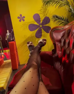 AI Video: takes off shoes and shows her pantyhosed feet