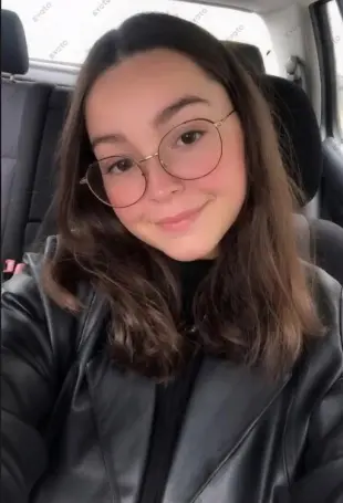 AI Video: The girl speaks to the camera for 2 seconds. Then she slowly opens her mouth...