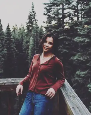 AI Video: Make the person stay up and looking playfully into the camera and bit her lip...