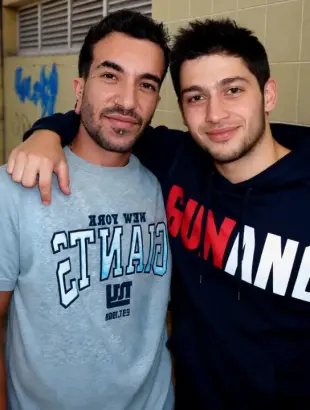 AI Video: The man on the right kisses the other man on the cheek. Then the man on the...