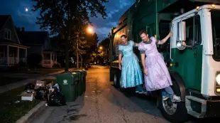 AI Video: Make me a garbage truck with two brown-haired men dressed in princess dresses...