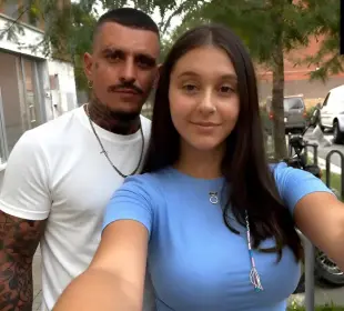 AI Video: The woman kisses the man on the mouth, then smiles to the camera until the...
