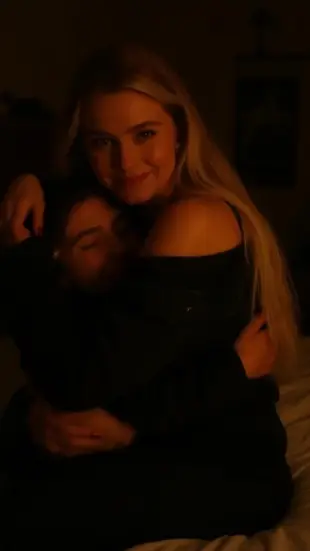 AI Video: A genuine smile spreads slowly, eyes soften, then wince as shoulders shift....