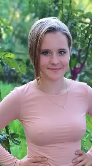 AI Video: She has her arms by her side doing the shimmy, jiggling, while seductively...