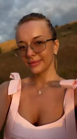 AI Video: She smiles softly, tilts head, leans in gently, chest rises, eyes sparkle,...