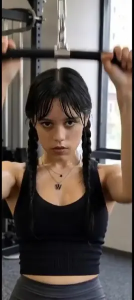 AI Video: Jenna ortega keeps doing her workout at gym on pull down machine sticking her...
