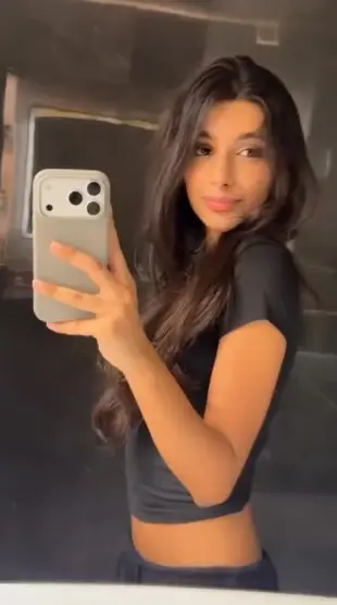 AI Video: she keeps her phone and hand stable , sheseductively bites her lower lip  ,...