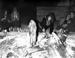 AI Video: Let the two girls on the left look surly; let the girl by the fire stoke it...