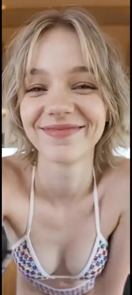 AI Video: Emma myers walks towards you, swinging her hips like a model  and sticking...