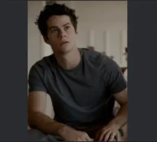 AI Video: stiles stiliski from teen wolf, running his hand through his hair and smiling