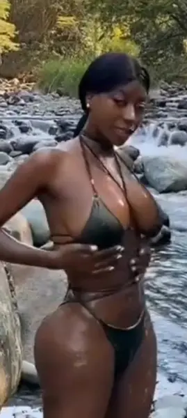 AI Video: African Beauty is bathing in river using foamy soap,